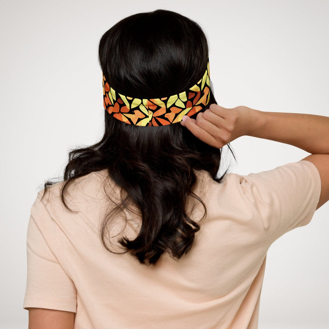 stretch headband with an abstract print in orange, yellow and brown by The Gabrielli