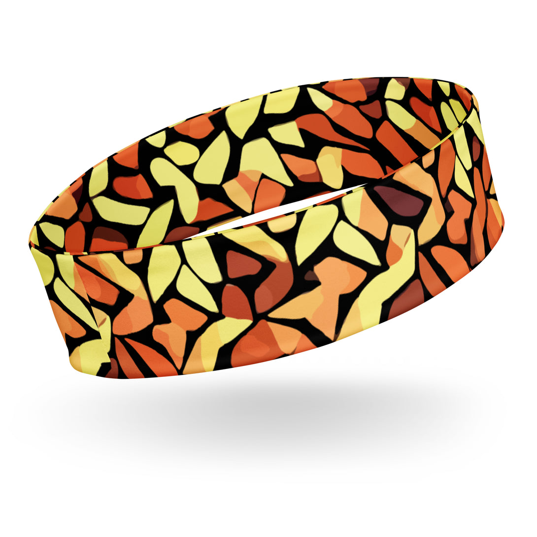 stretch headband with an abstract print in orange, yellow and brown by The Gabrielli