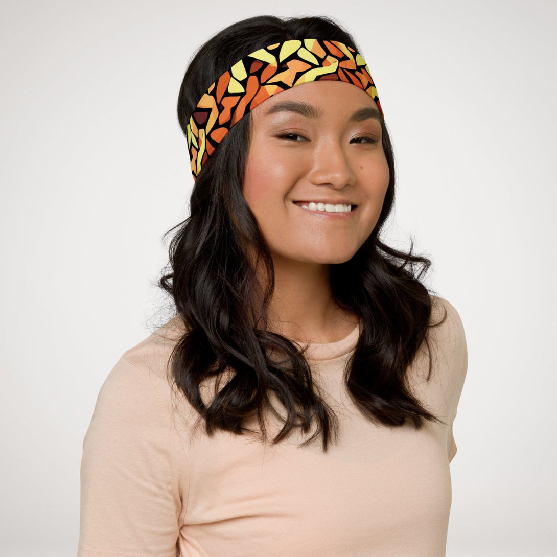 stretch headband with an abstract print in orange, yellow and brown by The Gabrielli