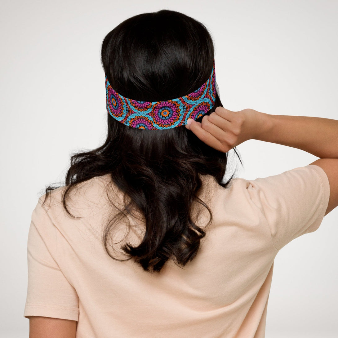 stretch headband with an abstract print in blue, pink, and orange by The Gabrielli