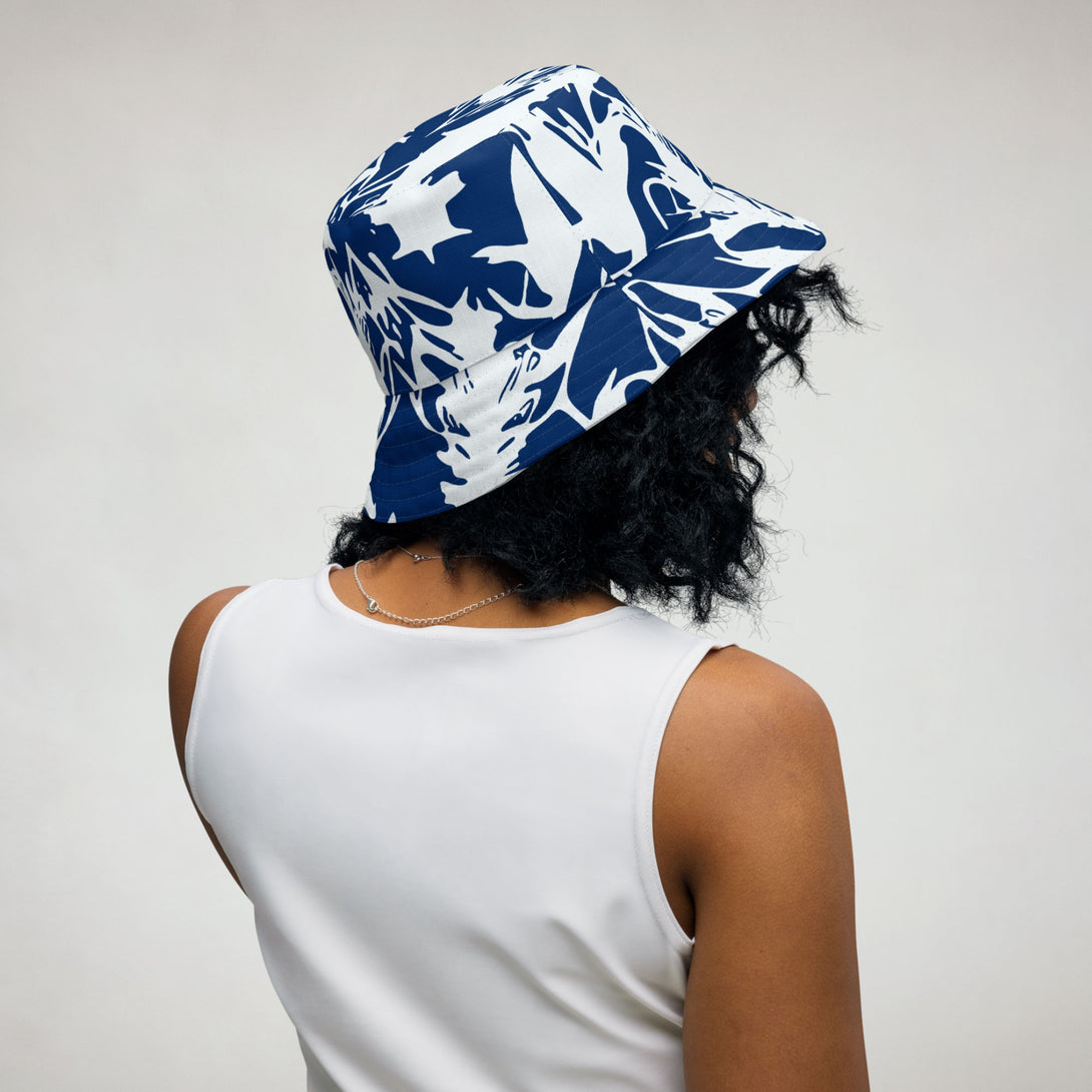 reversible bucket hat with abstract print in blue and white by The Gabrielli