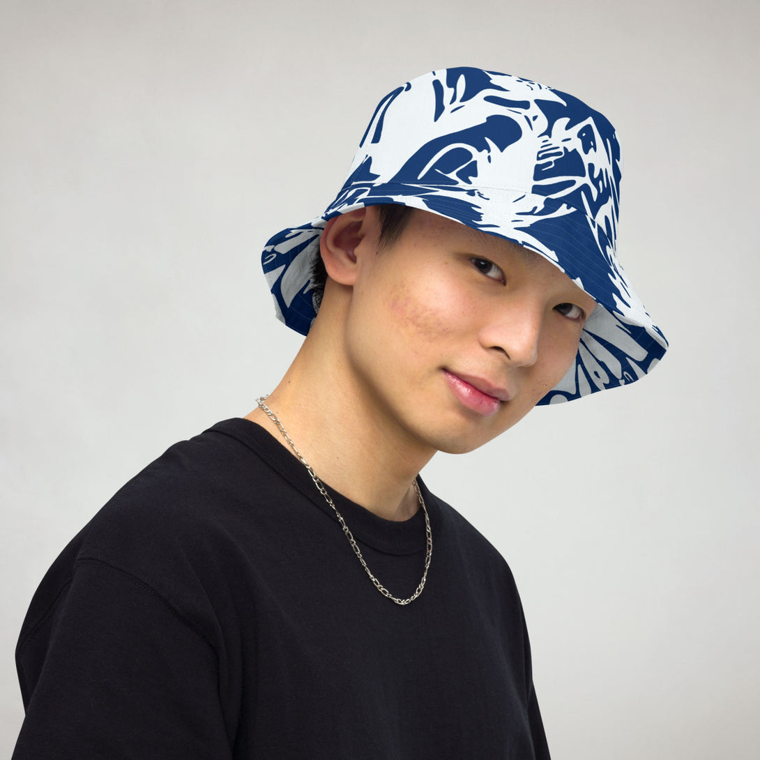 reversible bucket hat with abstract print in blue and white by The Gabrielli