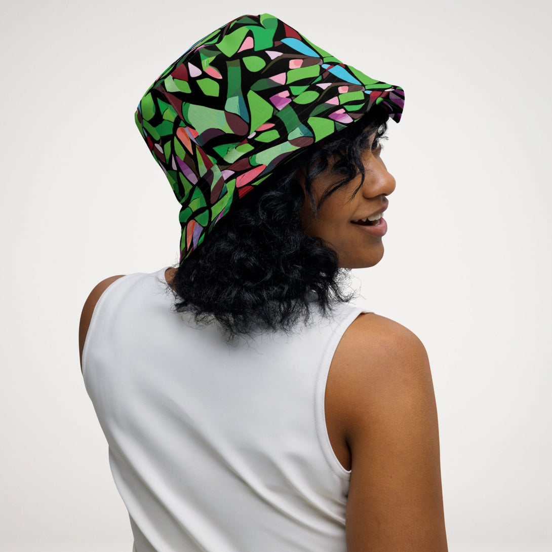 reversible bucket hat with a purple abstract print on one side and a green abstract print on the other side