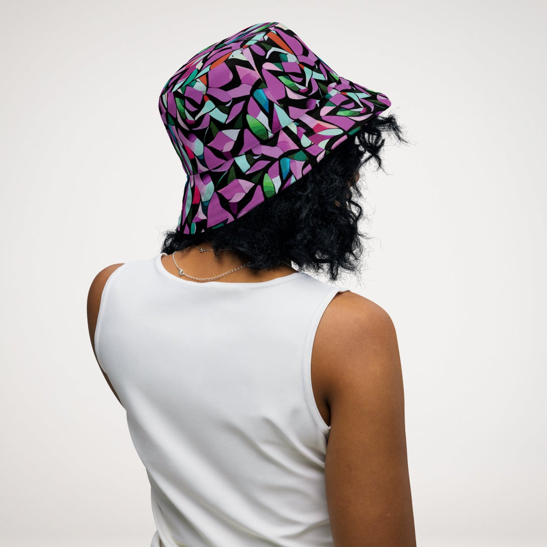 reversible bucket hat with a purple abstract print on one side and a green abstract print on the other side