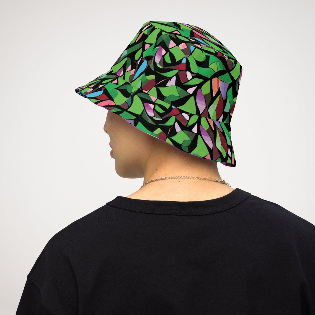 reversible bucket hat with a purple abstract print on one side and a green abstract print on the other side