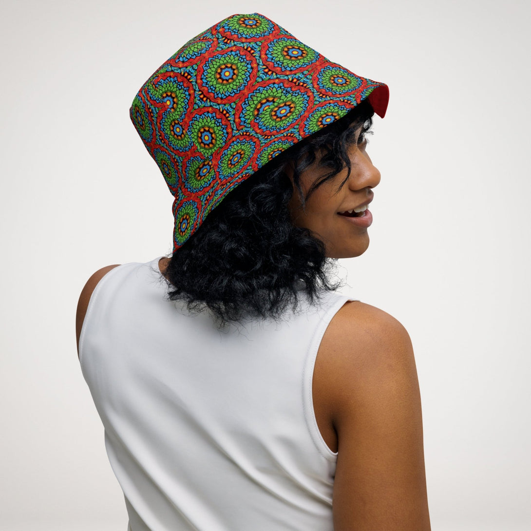 reversible bucket hat with an abstract print in green, blue, red and orange by The Gabrielli